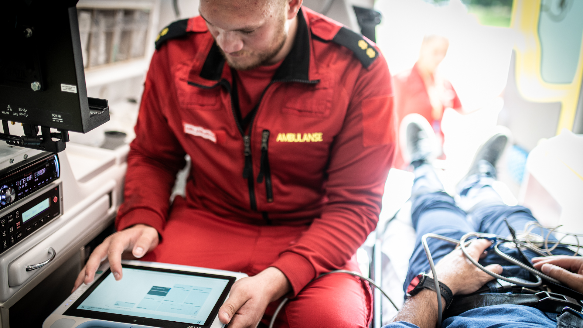 Paramedic monitoring tablet in ambulance